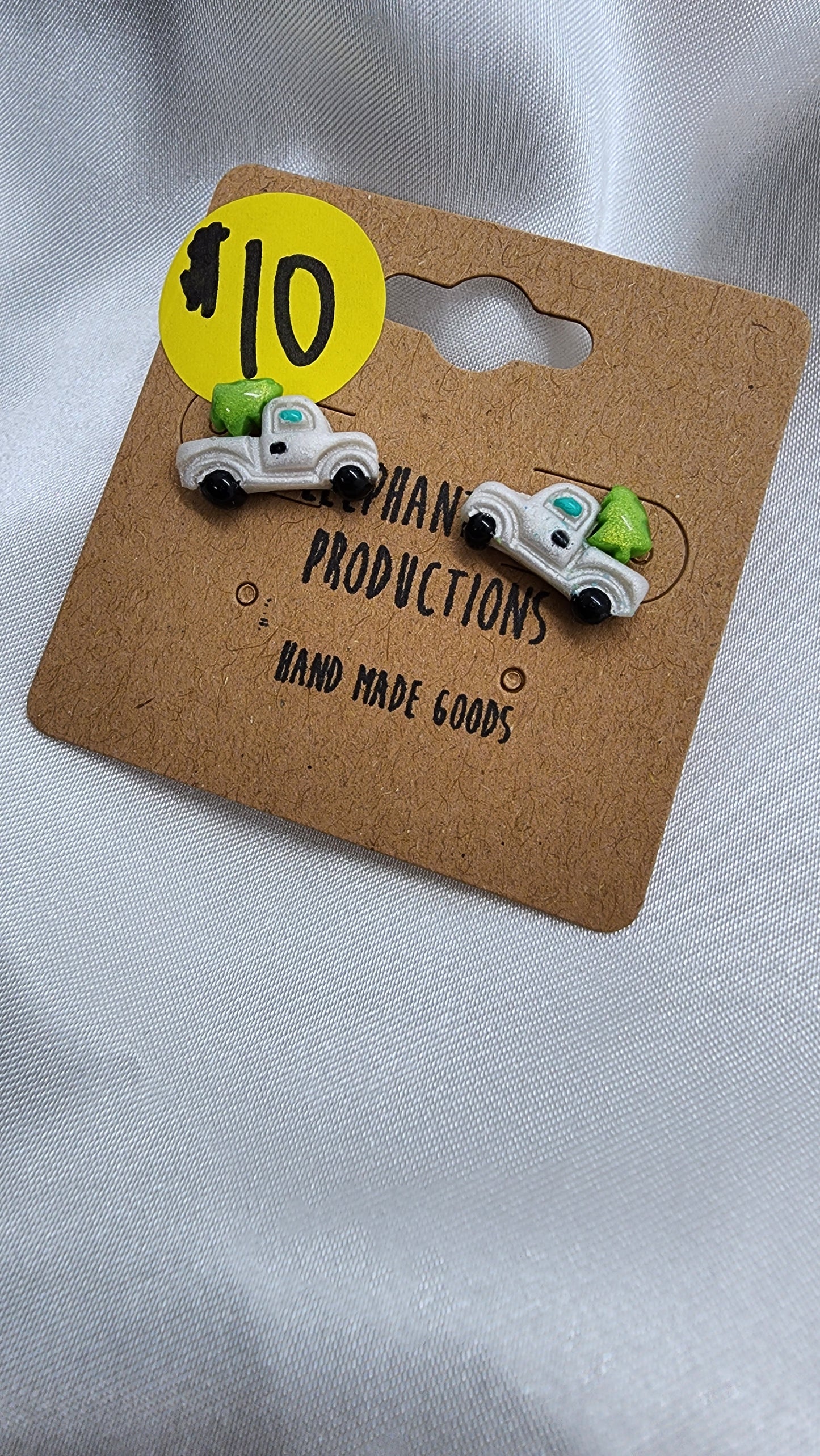 Little white truck hauling a Christmas tree earrings